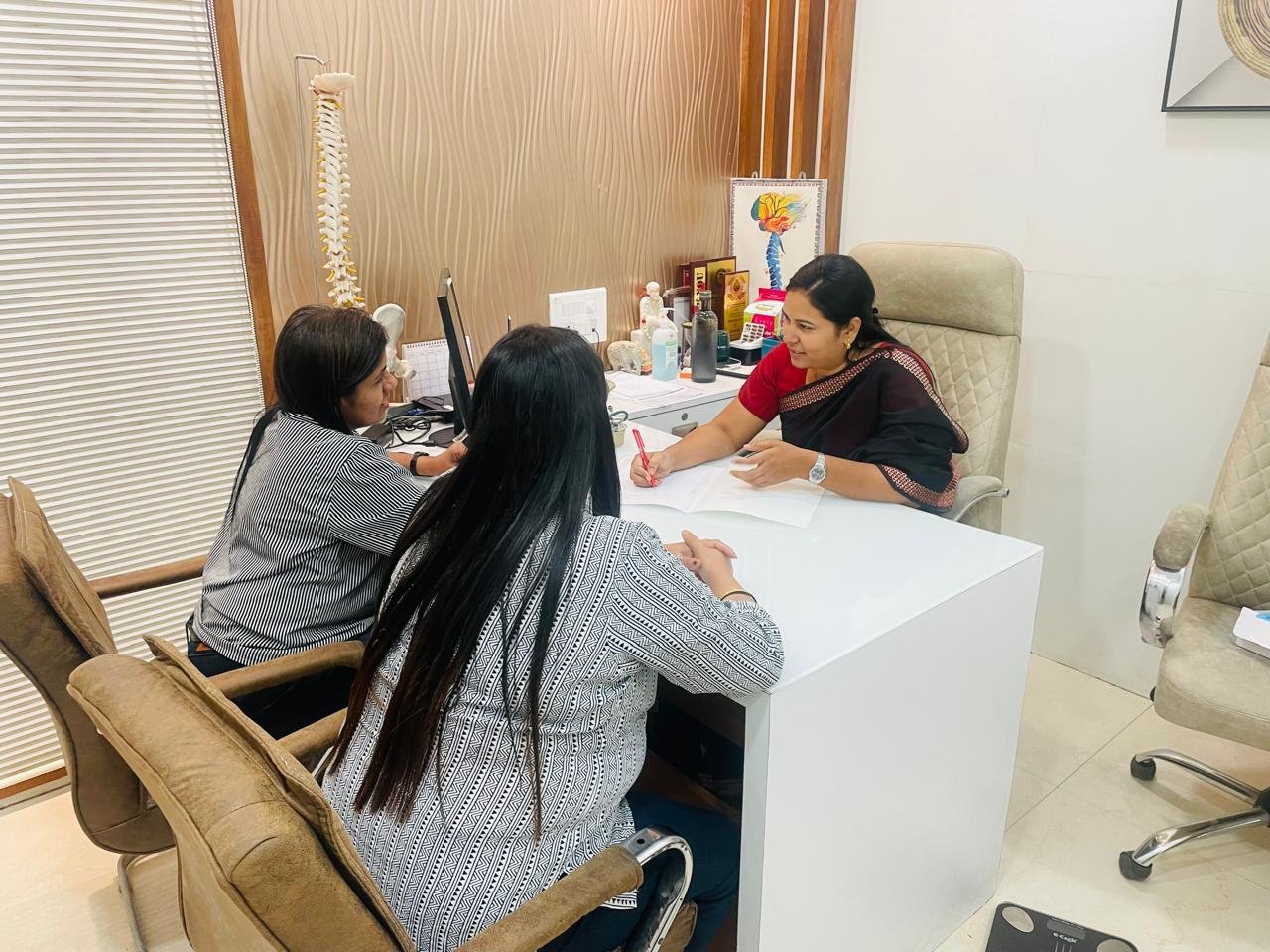 Dr. Kiran Shinde discussing scan results with a patient